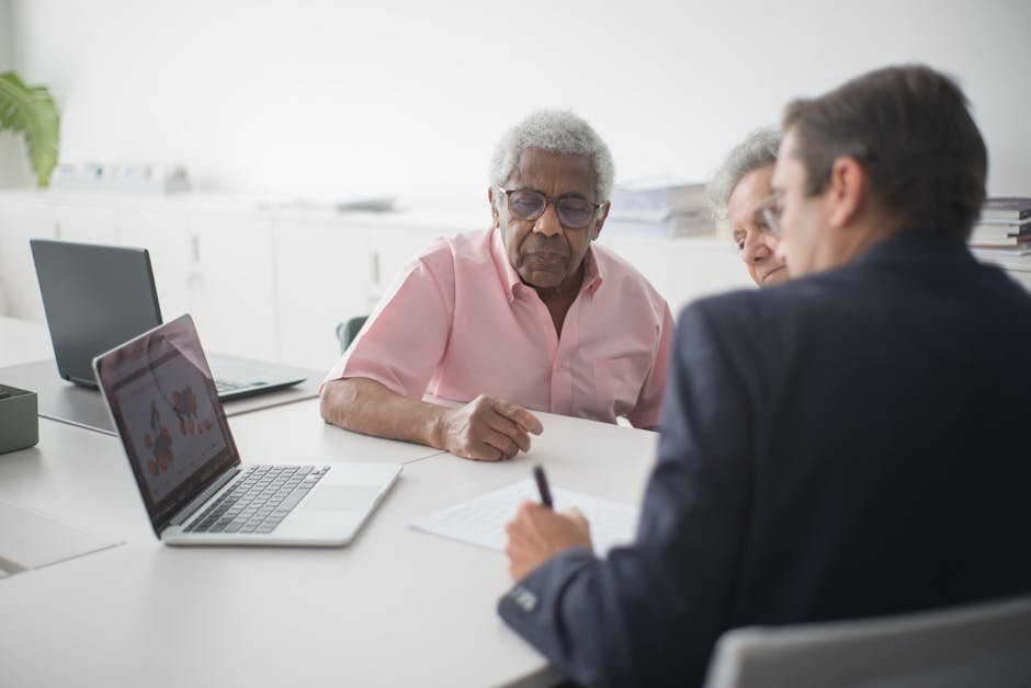 Senior couple meeting with insurance broker reviewing Medigap and indemnity options