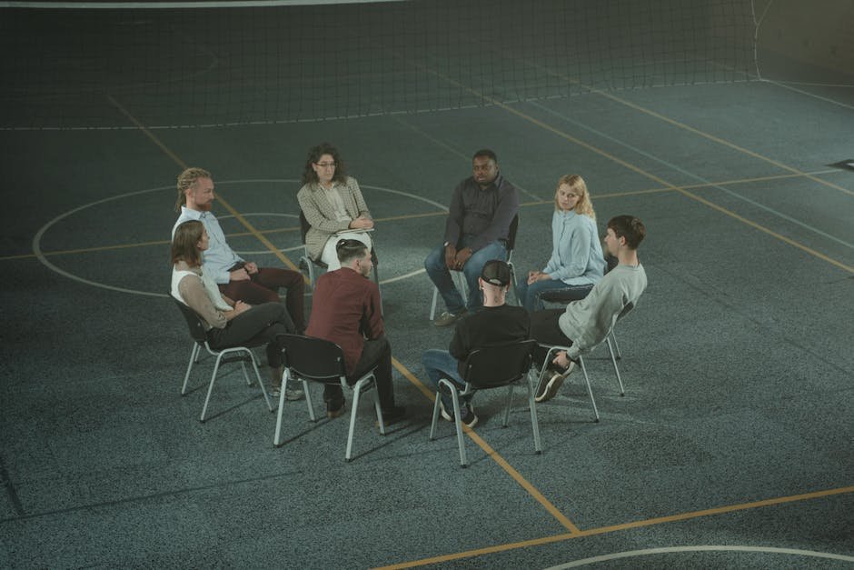 Group therapy circle in domestic violence intervention program with sliding scale fee discussion